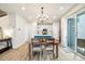 Bright dining area with wood floors, modern lighting, and easy access to the outdoor patio at 8586 Holman Ct # A, Arvada, CO 80005