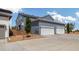 Attached two-car garage with white doors and gray siding for convenient parking at 8586 Holman Ct # A, Arvada, CO 80005