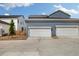 Attached two-car garage with white doors and gray siding for convenient parking at 8586 Holman Ct # A, Arvada, CO 80005