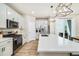 Modern kitchen boasting an island, stainless steel appliances, and a seamless connection to the dining area at 8586 Holman Ct # A, Arvada, CO 80005