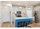 Well-equipped kitchen featuring an island, stainless steel appliances, white cabinets, and stylish pendant lights at 8586 Holman Ct # A, Arvada, CO 80005