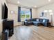 Cozy living room featuring a comfortable sectional sofa, large windows, and stylish decor at 8586 Holman Ct # A, Arvada, CO 80005