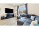 Comfortable living room with large gray sectional sofa and wood-style flooring at 8586 Holman Ct # A, Arvada, CO 80005