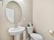 Charming powder room features pedestal sink, toilet, and neutral wall color at 8586 Holman Ct # A, Arvada, CO 80005