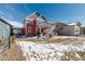 Exterior view of home with an expansive backyard and patio at 8775 El Diente St, Arvada, CO 80007