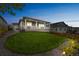 View of backyard featuring manicured lawn, a covered deck with white pillars and railings at 1148 Sunlit Dr, Castle Rock, CO 80109