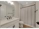 Bright bathroom featuring a white vanity with black hardware, a shower with a striped curtain, and modern finishes at 1148 Sunlit Dr, Castle Rock, CO 80109