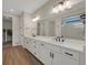 Elegant bathroom featuring a double vanity, granite countertops, and contemporary lighting at 1148 Sunlit Dr, Castle Rock, CO 80109