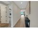 Hallway with hardwood floors leading to various rooms, showcasing the home's layout and design at 1148 Sunlit Dr, Castle Rock, CO 80109