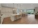 Gourmet kitchen flowing into living area, featuring a large island and modern finishes at 1148 Sunlit Dr, Castle Rock, CO 80109