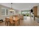 Open-concept living room with dining area, fireplace, and sliding doors to the outdoors at 1148 Sunlit Dr, Castle Rock, CO 80109