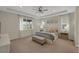 Spacious main bedroom with tray ceilings, plush carpeting, and abundant natural light from large windows at 1148 Sunlit Dr, Castle Rock, CO 80109