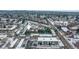 An aerial view of the apartments, with snow covered roofs, parking, and surrounding neighborhood at 2190 S Holly St # 207, Denver, CO 80222