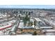 An aerial view of the apartments, surrounded by mature trees in a charming neighborhood after a recent snowfall at 2190 S Holly St # 207, Denver, CO 80222