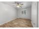 Bedroom featuring neutral walls, wood floors, and a window with white shutters at 2190 S Holly St # 207, Denver, CO 80222