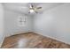 Bright bedroom with neutral walls, ceiling fan, wood floors, and a window with shutters at 2190 S Holly St # 207, Denver, CO 80222