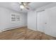 Bedroom with neutral walls, wood floors, double closet doors, and a window with shutters at 2190 S Holly St # 207, Denver, CO 80222