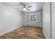 Bedroom featuring neutral walls, wood floors, and a window with open shutters at 2190 S Holly St # 207, Denver, CO 80222