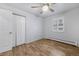 Bright bedroom with neutral walls, wood floors, double closet doors, and a window with shutters at 2190 S Holly St # 207, Denver, CO 80222