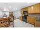 Eat-in kitchen offering a view into the Gathering room with fireplace and front entrance at 2190 S Holly St # 207, Denver, CO 80222