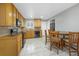 Cozy kitchen featuring wood cabinetry, matching dining set, and black appliances at 2190 S Holly St # 207, Denver, CO 80222