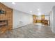 Spacious living room featuring a brick fireplace and seamless access to the adjacent kitchen and dining area at 2190 S Holly St # 207, Denver, CO 80222