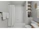 Bathroom with white tile shower and built in shelving at 2085 E 127Th Pl, Thornton, CO 80241