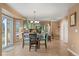 Open concept kitchen and dining area featuring stylish cabinetry, tile flooring, and seamless transition to the backyard at 2085 E 127Th Pl, Thornton, CO 80241