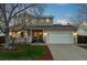 Charming two-story home featuring a well-manicured lawn, a welcoming porch, and a two-car garage at 2085 E 127Th Pl, Thornton, CO 80241