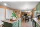 Open kitchen with stainless steel appliances, a center island, and seamless transition to the dining and living areas at 2085 E 127Th Pl, Thornton, CO 80241