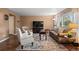 Cozy living room featuring neutral decor, a large window, and hardwood floors throughout at 2085 E 127Th Pl, Thornton, CO 80241
