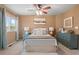 Comfortable main bedroom with ceiling fan, stylish furniture, and bright window at 2085 E 127Th Pl, Thornton, CO 80241