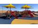 Vibrant community playground featuring slides, climbing structures, and colorful shade canopies at 2085 E 127Th Pl, Thornton, CO 80241