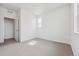 Bright bedroom featuring neutral carpet, a window, and an open closet at 6794 Merseyside Ln, Castle Pines, CO 80108