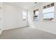 Well-lit bedroom with large windows, plush carpeting, and neutral walls at 6794 Merseyside Ln, Castle Pines, CO 80108