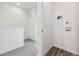 Hallway view of a laundry room with a washer hookup on white walls and wood-style floors at 6794 Merseyside Ln, Castle Pines, CO 80108