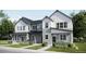 Charming two-story townhome with a modern farmhouse facade, lush landscaping, and inviting curb appeal at 6639 Parterre N Pkwy # 3, Thornton, CO 80602
