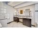 Elegant bathroom featuring dual sinks, marble countertops, and modern lighting at 9451 Desert Willow Trl, Highlands Ranch, CO 80129