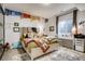Charming bedroom features bright decor, a comfy bed, and a window illuminating a built-in desk at 9451 Desert Willow Trl, Highlands Ranch, CO 80129