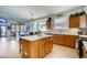 Modern kitchen with light wood cabinets, quartz countertops, and a functional center island at 9451 Desert Willow Trl, Highlands Ranch, CO 80129