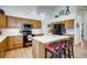Modern kitchen featuring stainless steel appliances, quartz countertops, and an island with seating at 9451 Desert Willow Trl, Highlands Ranch, CO 80129