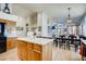 Open-concept kitchen featuring wooden cabinets, white counters and seamless view of dining and living areas at 9451 Desert Willow Trl, Highlands Ranch, CO 80129