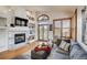 Cozy living room featuring a fireplace, built-in shelving, and natural light at 9451 Desert Willow Trl, Highlands Ranch, CO 80129