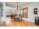 Open-plan living room with hardwood floors, chandelier, and a piano, reflected in a mirrored wall at 9451 Desert Willow Trl, Highlands Ranch, CO 80129