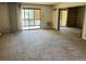 Spacious living room with carpet, access to balcony, and potential for customization at 13601 E Marina Dr # 305, Aurora, CO 80014