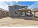 Exterior of home featuring a patio with sliding glass doors and yard space at 9672 Cathay St, Commerce City, CO 80022
