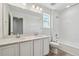 Bathroom featuring a double vanity with quartz countertops at 9672 Cathay St, Commerce City, CO 80022