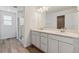 Modern bathroom featuring double vanity, quartz countertops, and walk-in shower at 9672 Cathay St, Commerce City, CO 80022