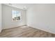 Bright, empty bedroom featuring a large window and light, plank-style flooring at 9672 Cathay St, Commerce City, CO 80022