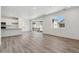 Open concept living room with lots of light from windows and sliding doors. Plank flooring throughout at 9672 Cathay St, Commerce City, CO 80022